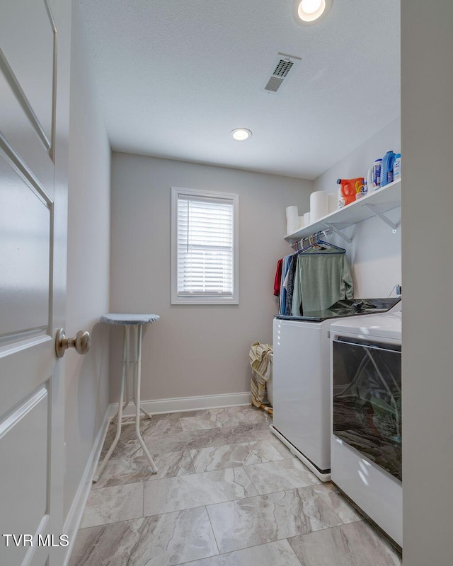 clothes washing area featuring visible vents, baseboards, washer and clothes dryer, laundry area, and marble finish floor