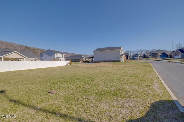 view of yard with a residential view and fence