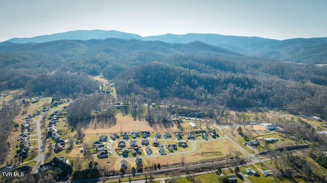 bird's eye view with a forest view and a mountain view