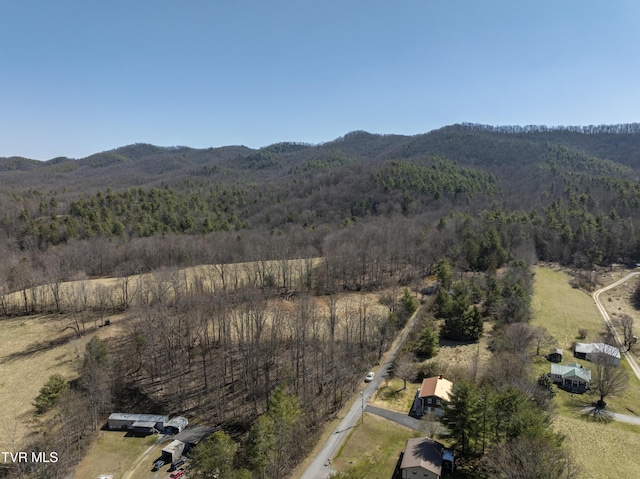 bird's eye view with a mountain view and a wooded view