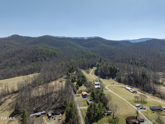 aerial view featuring a forest view and a mountain view