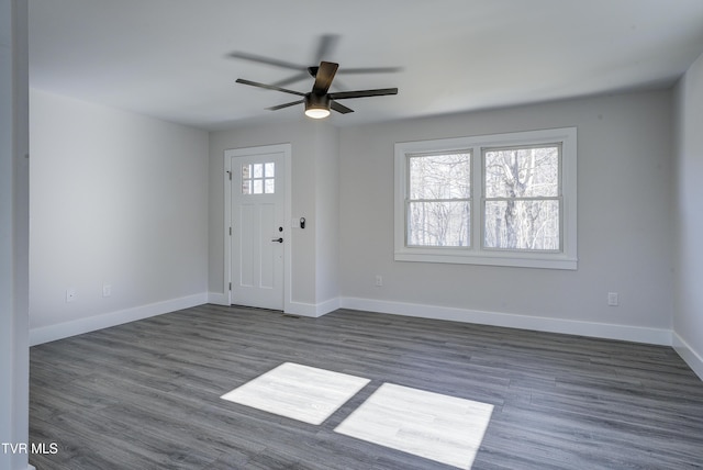 foyer entrance with ceiling fan, baseboards, and dark wood-style flooring