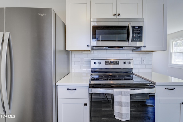 kitchen featuring decorative backsplash, white cabinetry, stainless steel appliances, and light countertops