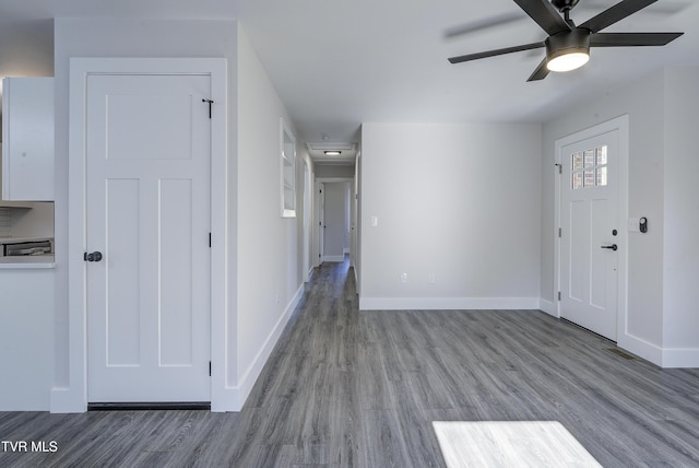 foyer with ceiling fan, baseboards, and wood finished floors