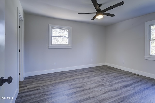 unfurnished bedroom with dark wood finished floors, visible vents, and baseboards