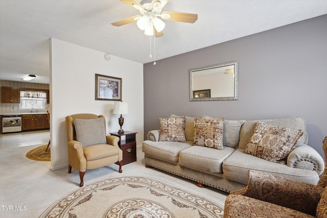 living area featuring a ceiling fan and light carpet