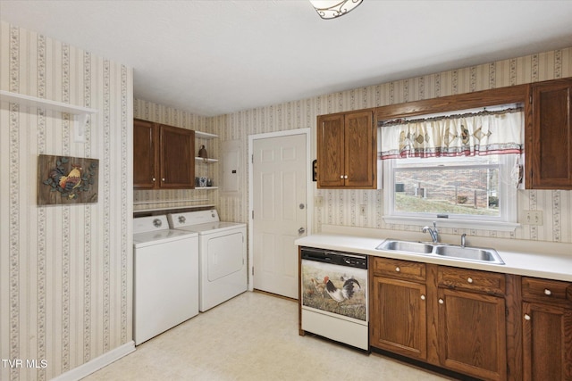 kitchen featuring a sink, separate washer and dryer, dishwasher, and wallpapered walls