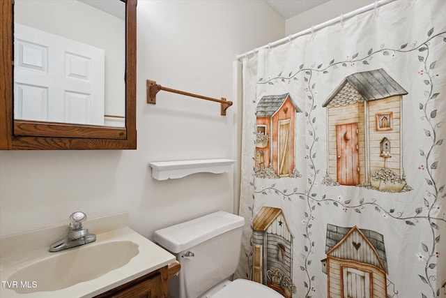 bathroom featuring a shower with curtain, toilet, and vanity