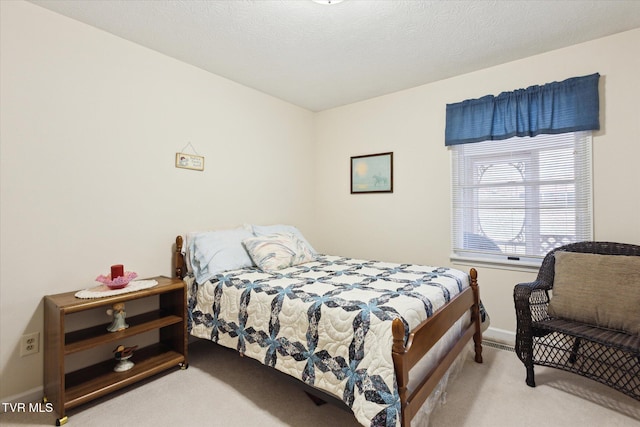 carpeted bedroom featuring baseboards and a textured ceiling