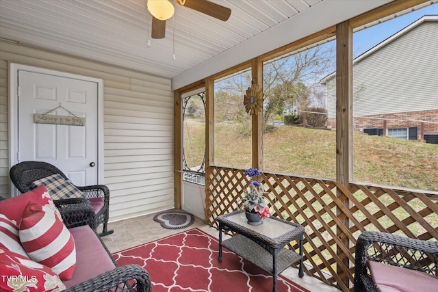 sunroom / solarium featuring ceiling fan