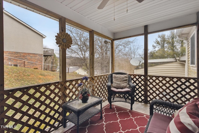 sunroom / solarium featuring a healthy amount of sunlight and ceiling fan