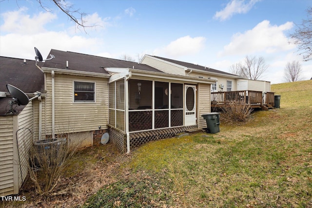 back of property with a lawn, central AC, a deck, and a sunroom