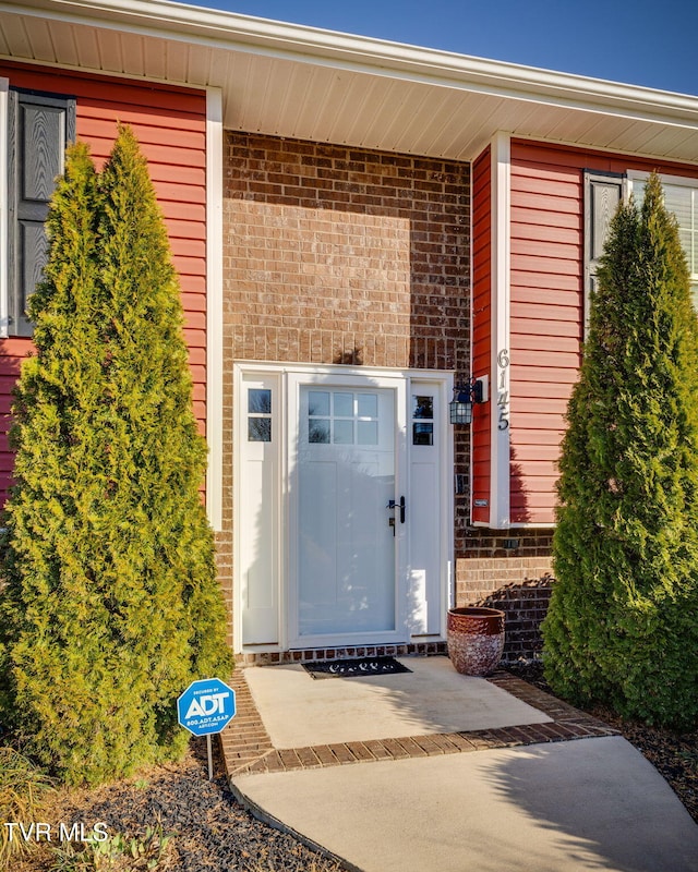 property entrance with brick siding