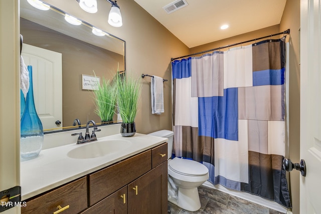 bathroom with vanity, curtained shower, toilet, and visible vents