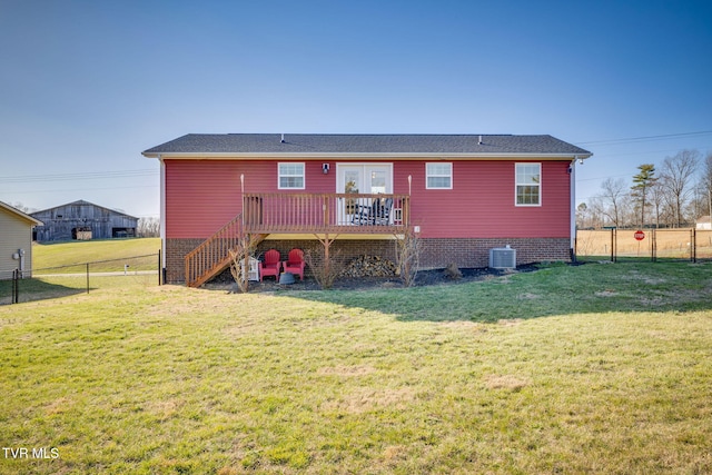 back of property with central air condition unit, fence, a lawn, and a wooden deck