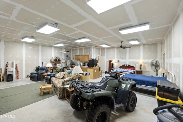 garage featuring freestanding refrigerator and a ceiling fan