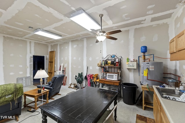 interior space featuring ceiling fan, concrete floors, and electric water heater