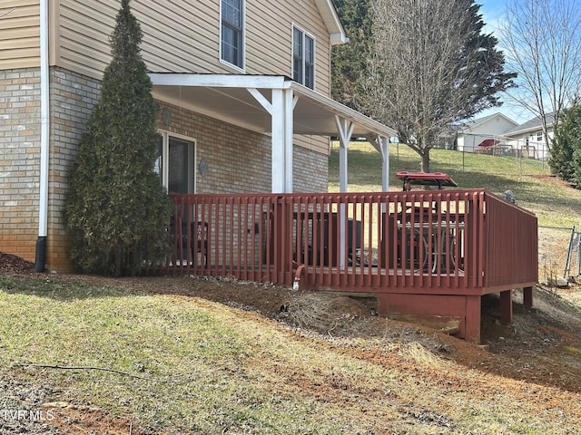 wooden deck with a lawn