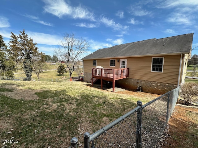 back of house with a lawn, a deck, and fence