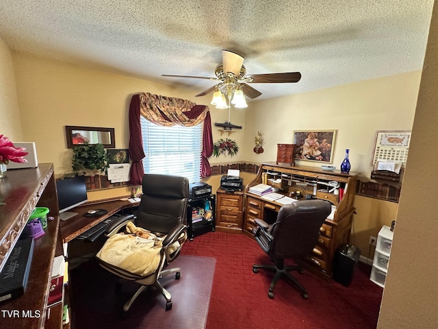 home office featuring a ceiling fan, carpet, and a textured ceiling