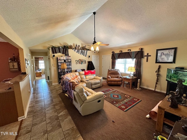 living room with ceiling fan, vaulted ceiling, baseboards, and a textured ceiling