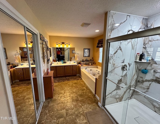 bathroom featuring a marble finish shower, visible vents, vanity, a garden tub, and a textured ceiling