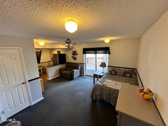 carpeted bedroom featuring access to exterior, a textured ceiling, and freestanding refrigerator