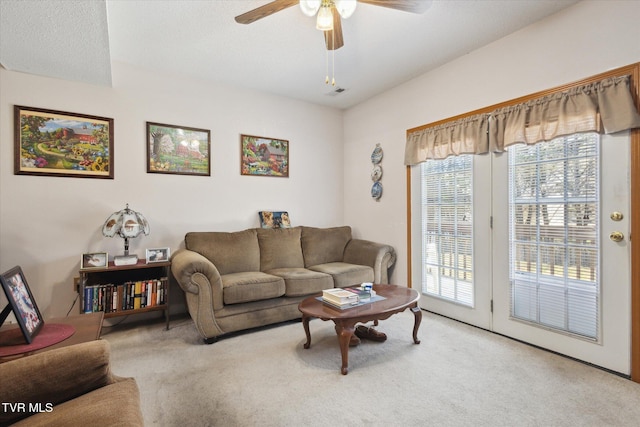 living room with carpet flooring and ceiling fan