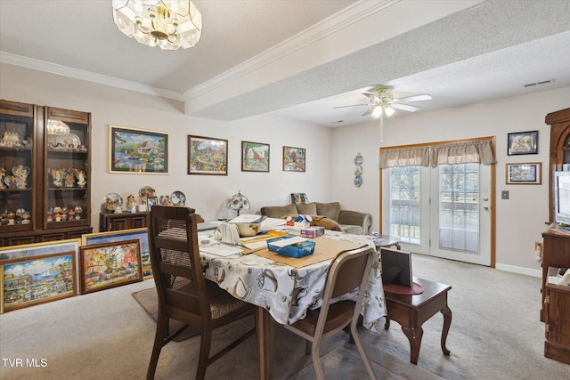 dining space with baseboards, visible vents, ornamental molding, a textured ceiling, and carpet flooring