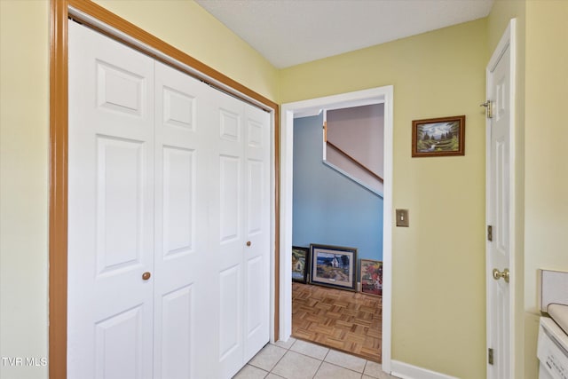 hall with light tile patterned floors and baseboards