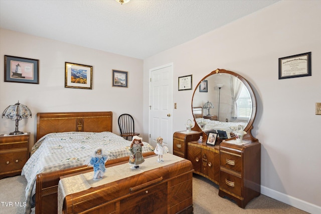 bedroom with baseboards and light carpet