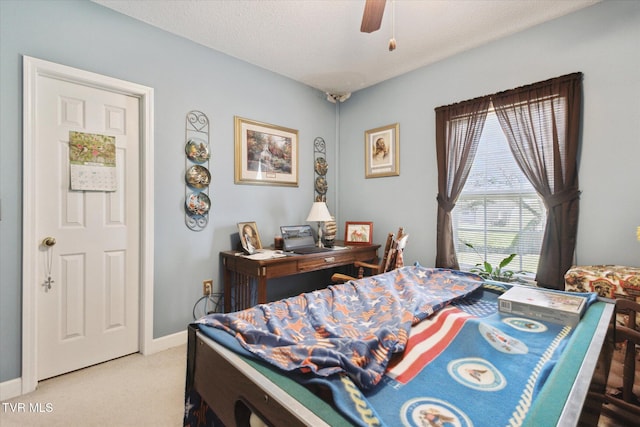 bedroom featuring baseboards, carpet, a ceiling fan, and a textured ceiling