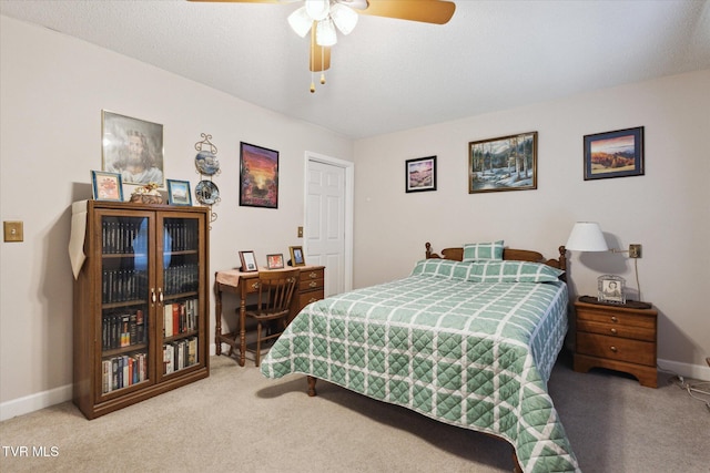 bedroom featuring baseboards, carpet floors, and a ceiling fan