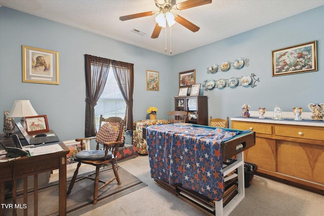 bedroom featuring light colored carpet, visible vents, and a textured ceiling