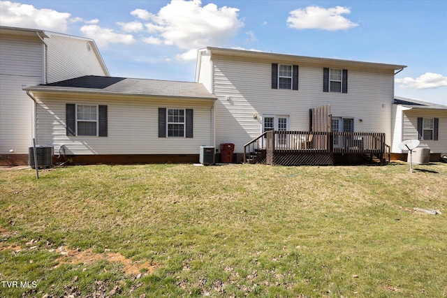 back of property with a deck, a lawn, and central AC