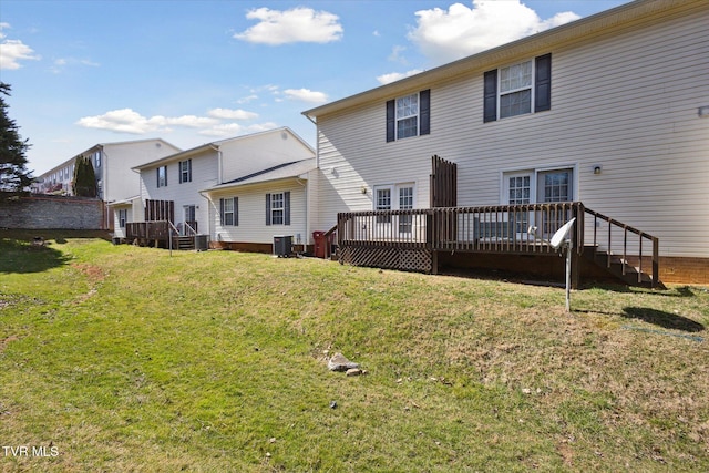 back of property featuring cooling unit, a yard, and a deck