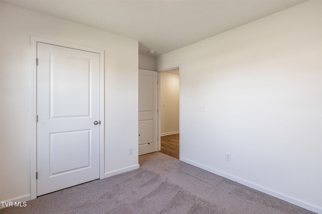 unfurnished bedroom with baseboards and carpet floors