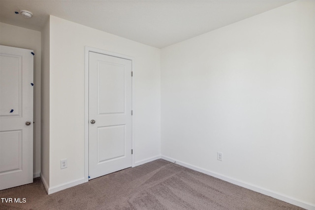 unfurnished bedroom with baseboards and carpet floors