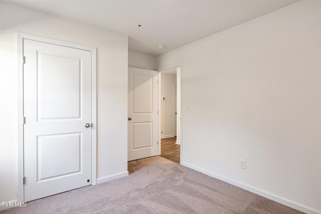 unfurnished bedroom with carpet and baseboards