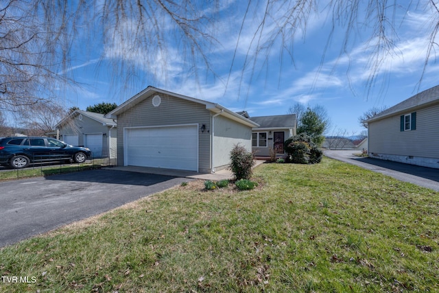 ranch-style house featuring aphalt driveway, a garage, and a front lawn