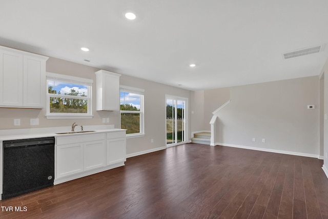 kitchen with visible vents, a sink, light countertops, black dishwasher, and open floor plan