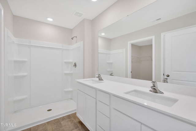 1123 Aspen Ter, Greeneville, TN 37745 - bathroom featuring visible vents, a sink, a stall shower, and a walk in closet