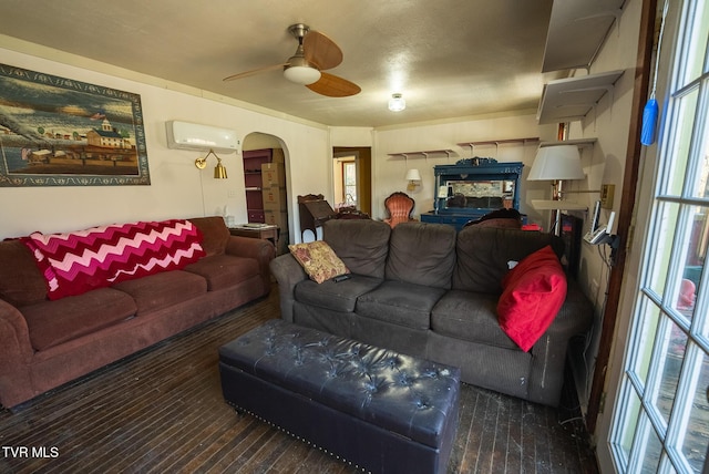 living area featuring a ceiling fan, arched walkways, and a wall mounted air conditioner