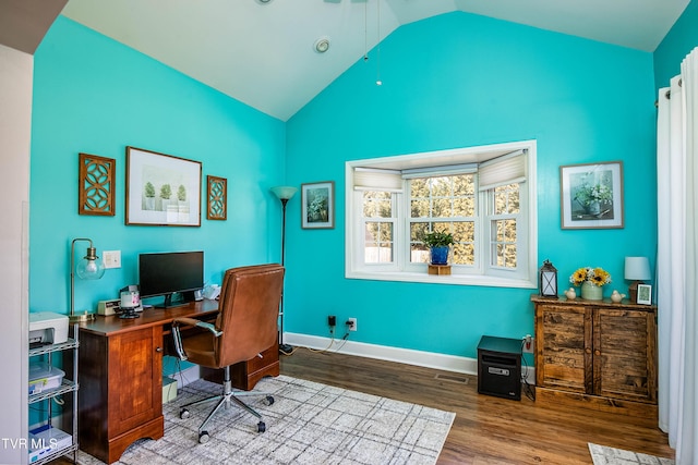 home office with visible vents, baseboards, lofted ceiling, and wood finished floors