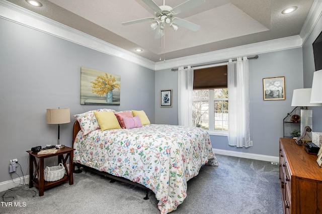 bedroom featuring a tray ceiling, a textured ceiling, carpet floors, crown molding, and baseboards