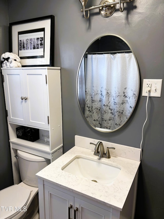 full bathroom featuring vanity and toilet