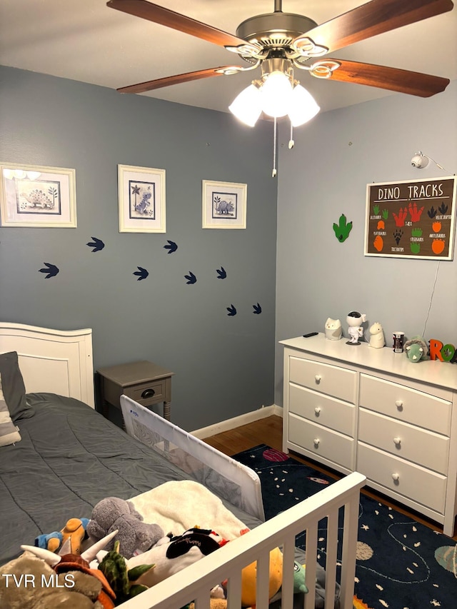 bedroom with wood finished floors, baseboards, and ceiling fan