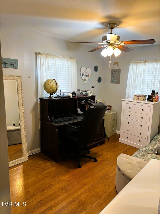 office with baseboards, ceiling fan, and wood finished floors