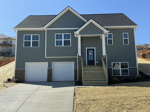 view of front of home with a garage, brick siding, concrete driveway, and a shingled roof