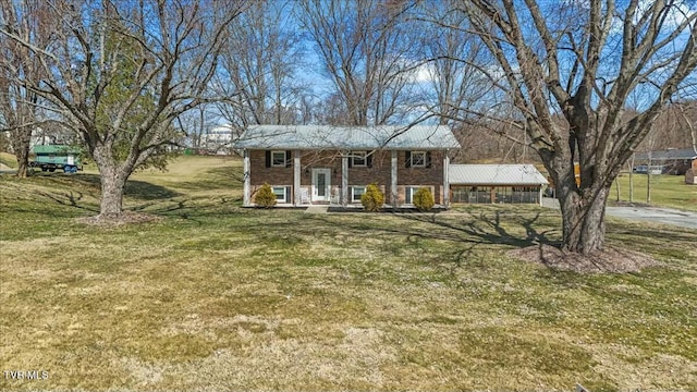 view of front facade featuring brick siding, a porch, and a front lawn